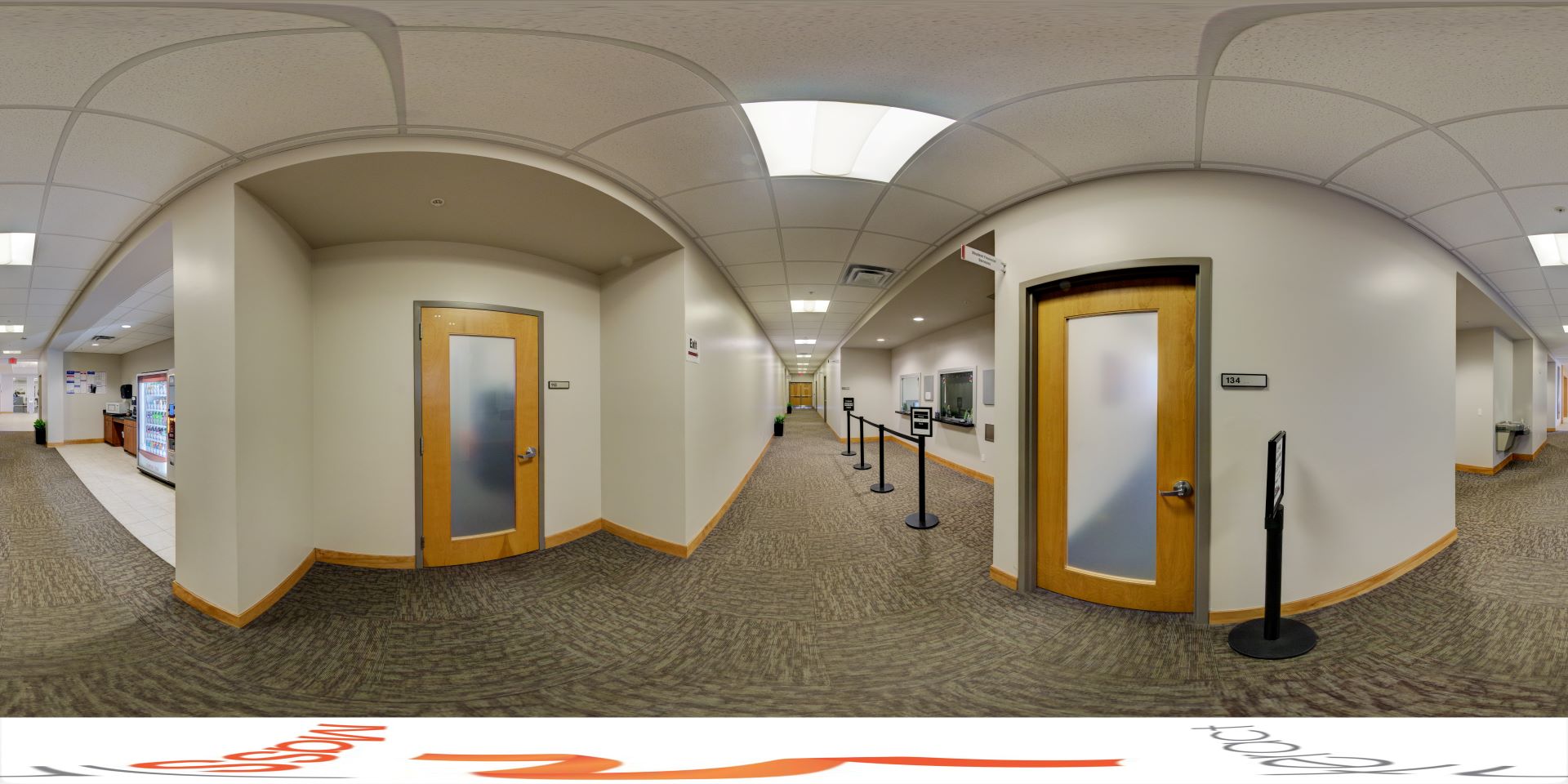 Hallway in the L3Harris Commons at Florida Tech, featuring office doors and a vending area, leading to the Financial Aid office